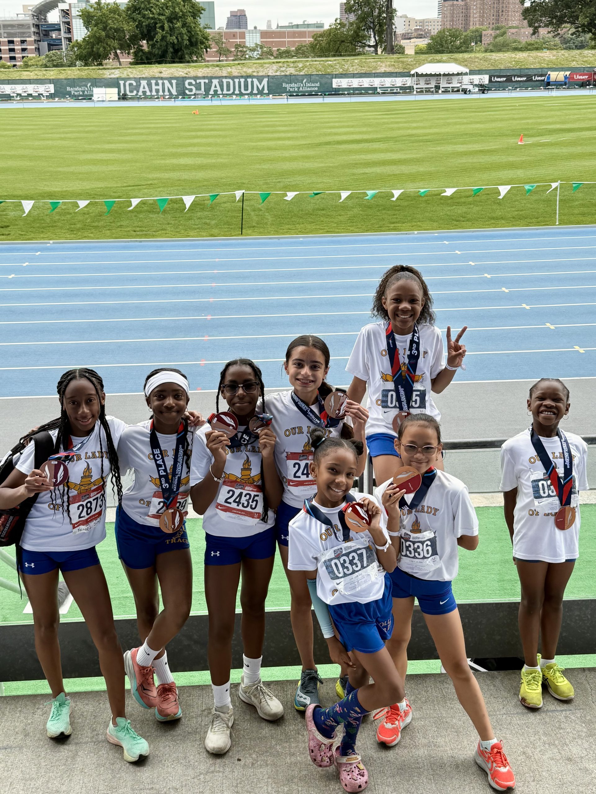 OLL Elite team at Icahn Stadium with medals