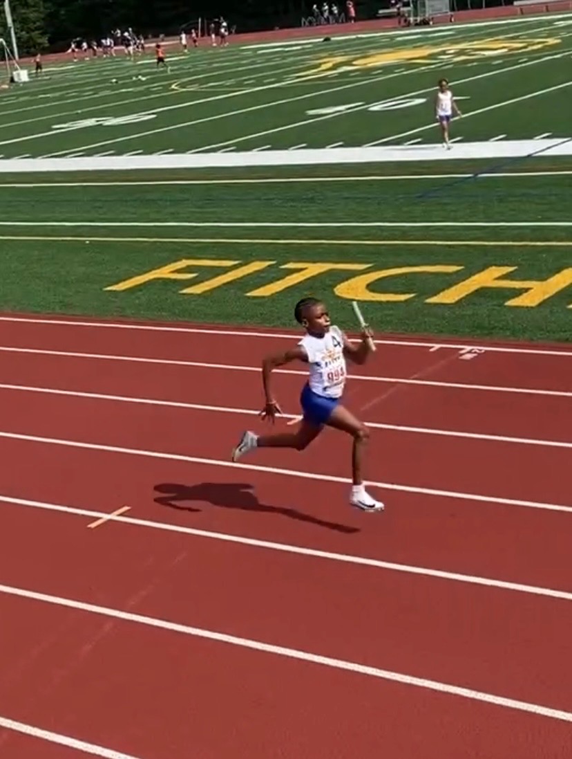 OLL Elite athlete sprinting with relay baton